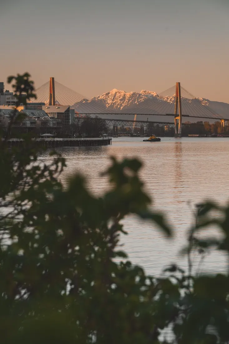 Surrey, BC — Fraser River, bridge and North Shore mountains at sunset
